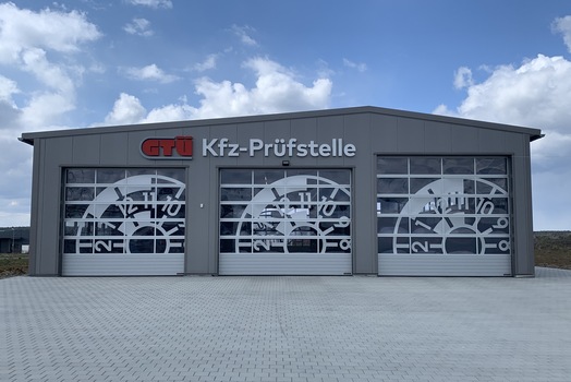 GTÜ Kfz-Prüfstelle in einer Stahlhalle mit drei verglasten Sektionaltoren